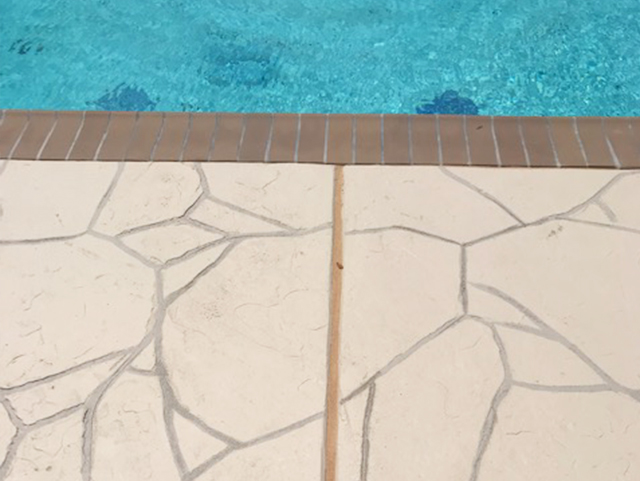 stone patterned decking by pool edge